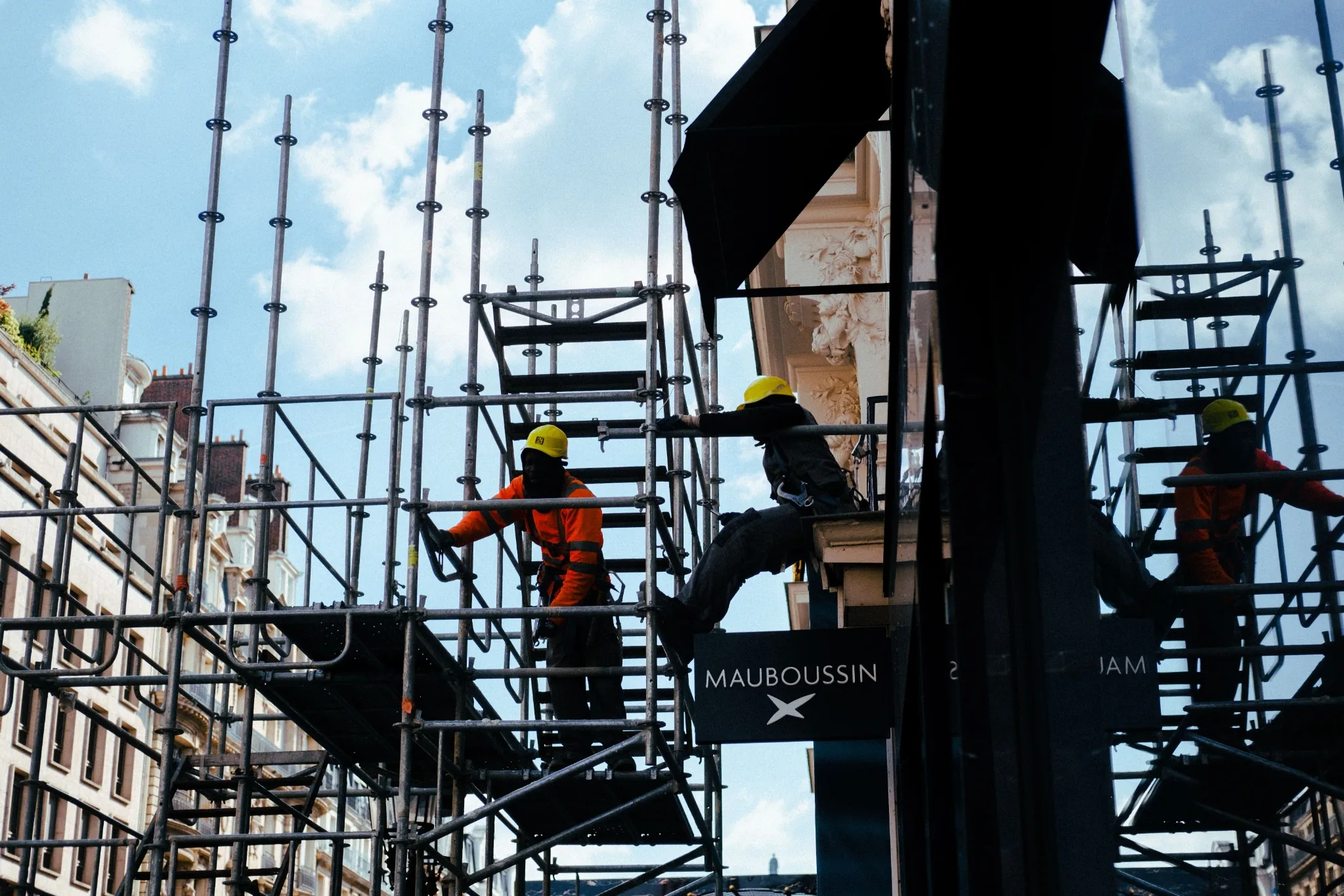 Construction workers on scaffolding at a building site