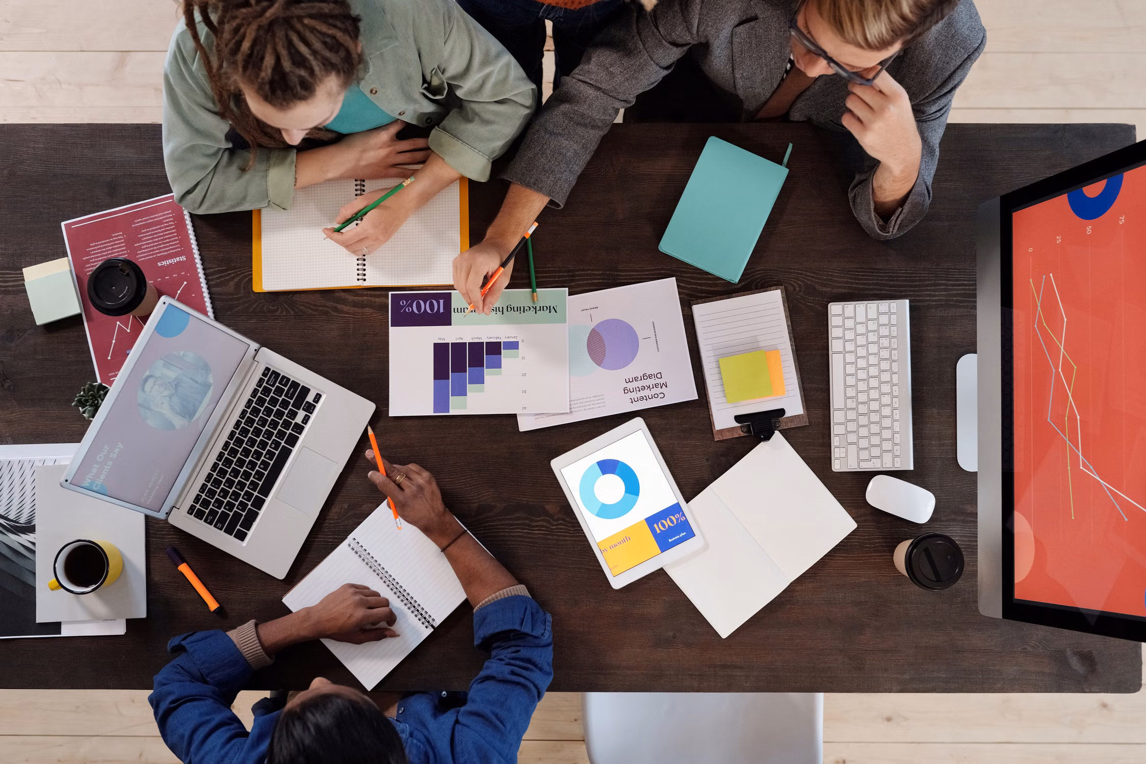 Executive team reviewing portfolio data together in a modern office