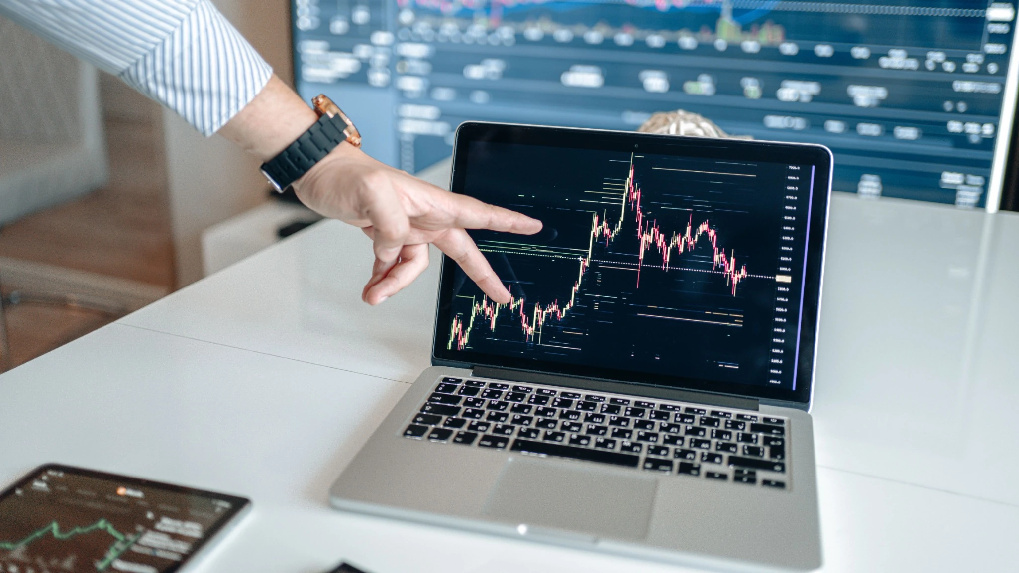 Investor reviewing portfolio data and financial charts on a laptop
